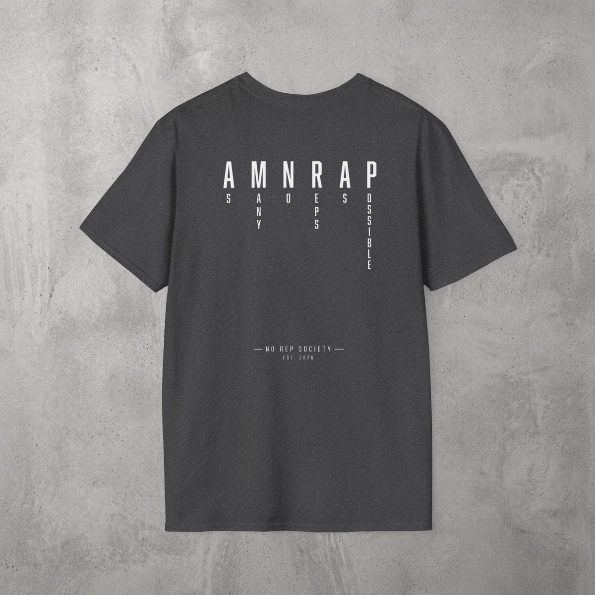 Dark Heather AMNRAP Tee by The No Rep Society, flat lay on grey concrete, back print of AMNRAP in wide spaced capitals with AS MANY NO-REPS AS POSSIBLE set vertically between the letters.