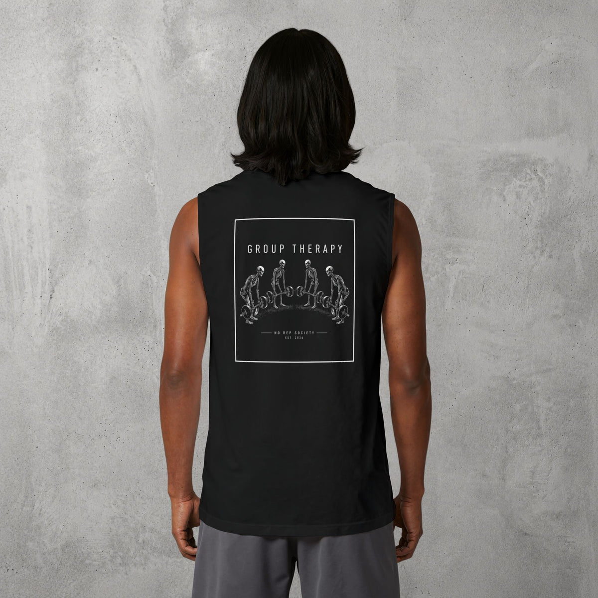 Black Group Therapy Muscle Tank worn by a female model, back view showing the Group Therapy print.