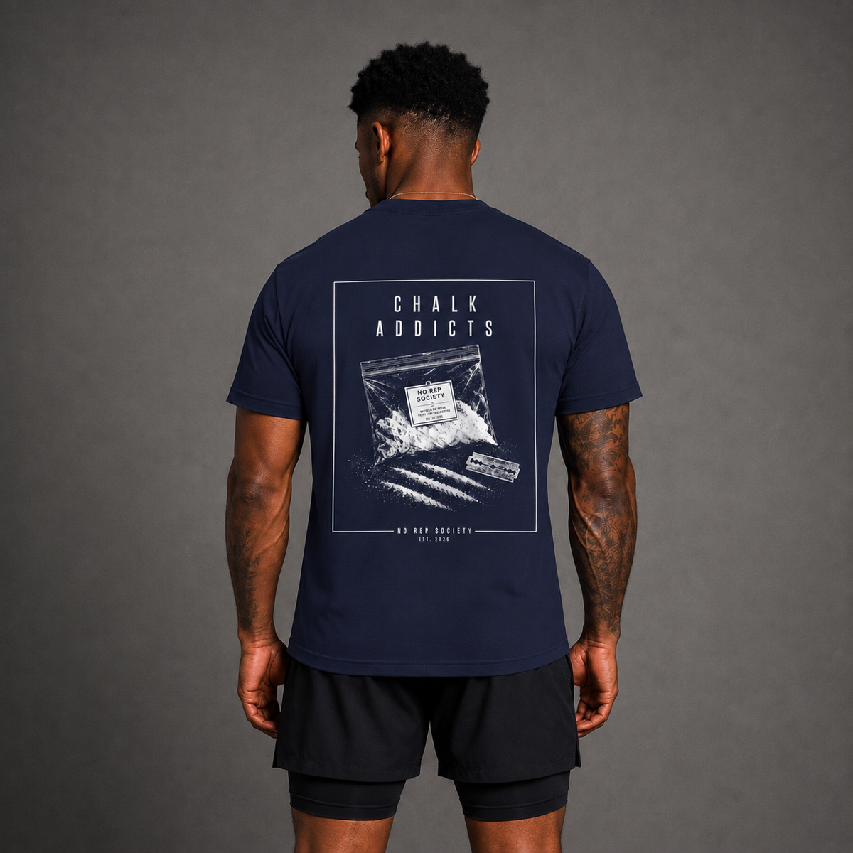 Navy Chalk Addicts Tee by The No Rep Society, worn by a male model, back view showing the CHALK ADDICTS print.
