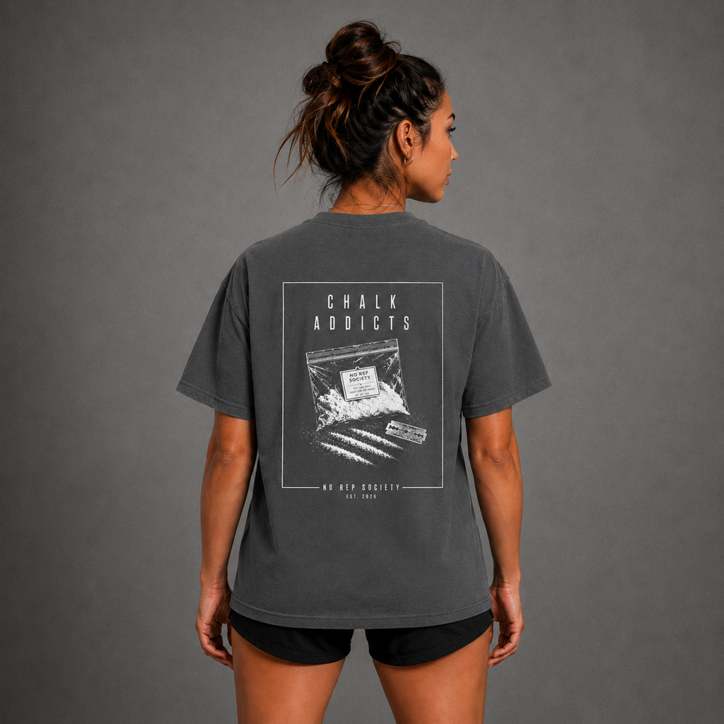 Dark Heather Chalk Addicts Tee by The No Rep Society, worn by a female model, back view showing the CHALK ADDICTS print.