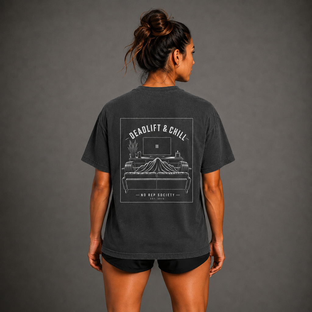 Dark Heather Deadlift & Chill Tee by The No Rep Society, worn by a female model, back view showing the DEADLIFT & CHILL print.